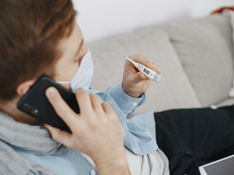 A person holding a thermometer