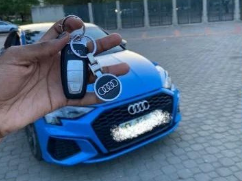 A person holding the keys to a new car