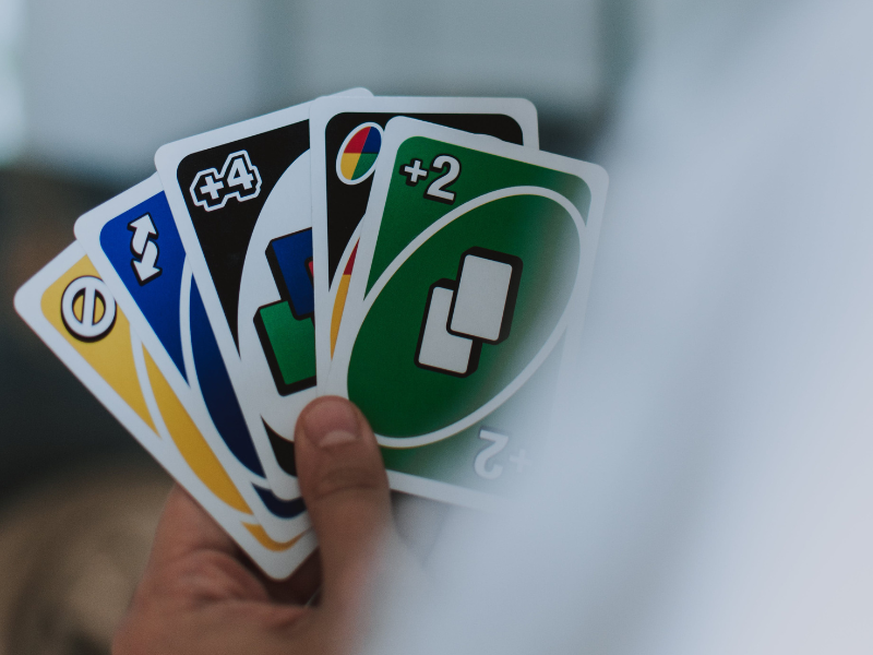 A person holding uno cards