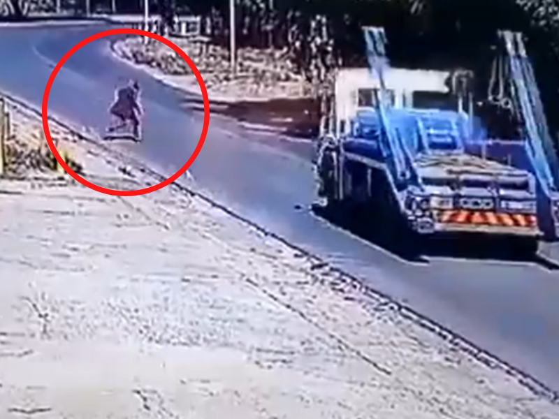 A person jumping in front of a moving truck
