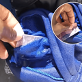 A person pulls money out of a wet pant pocket