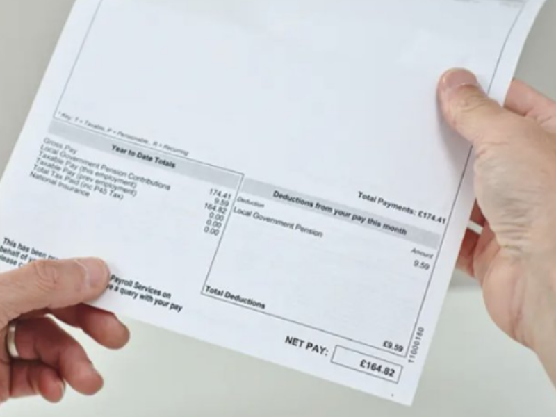 A person reading their salary slip