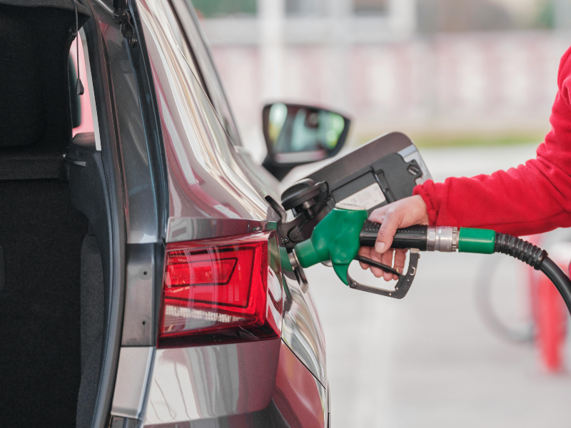 A person refueling their car at a gas station