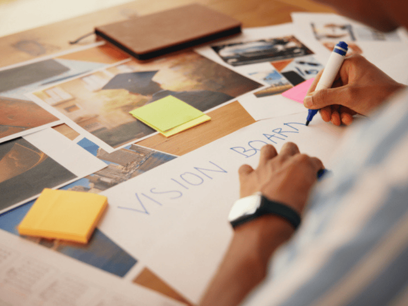 A person working on their vision board