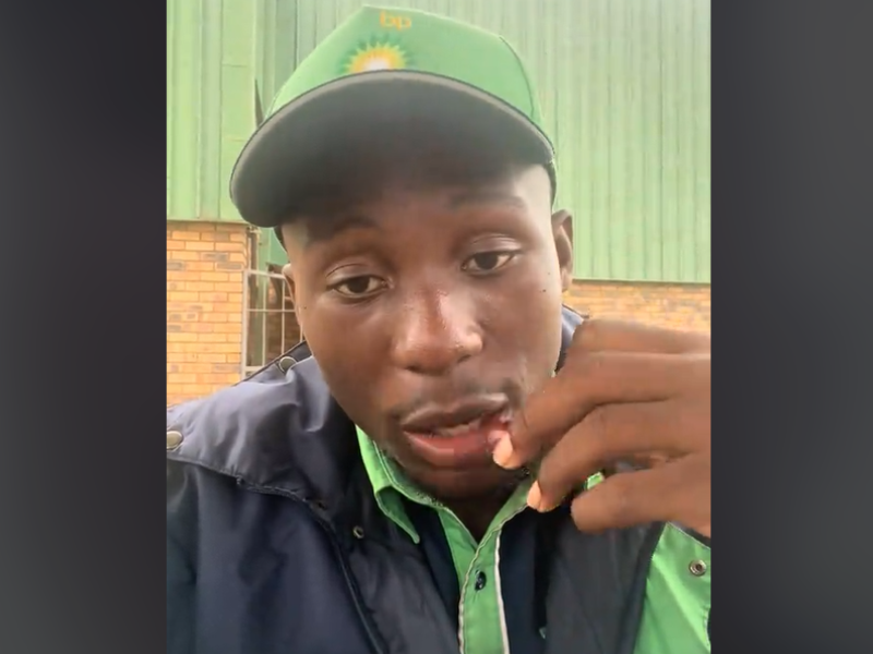 A petrol attendant from BP eating grapes