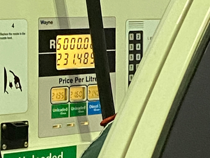 A petrol station pump with R5,000 bill