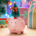 A pink piggy bank with a green decorated Christmas tree
