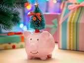 A pink piggy bank with a green decorated Christmas tree