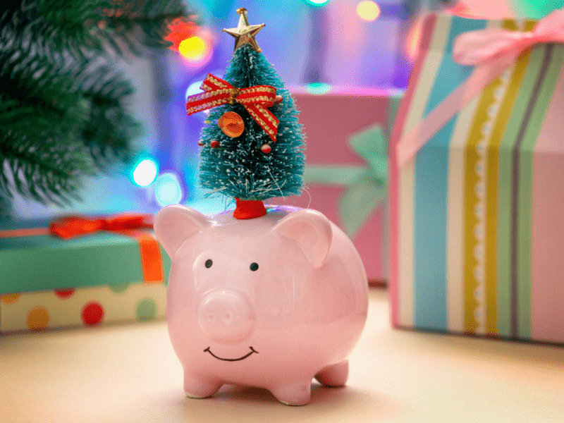 A pink piggy bank with a green decorated Christmas tree