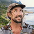 A poster of Jeremy Loops with the ocean in the background