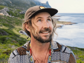 A poster of Jeremy Loops with the ocean in the background