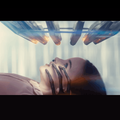An alien hand touches a girl's face