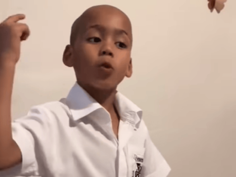 A school boy uses his hands while speaking