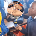 A schoolboy proposes to a schoolgirl in their classroom