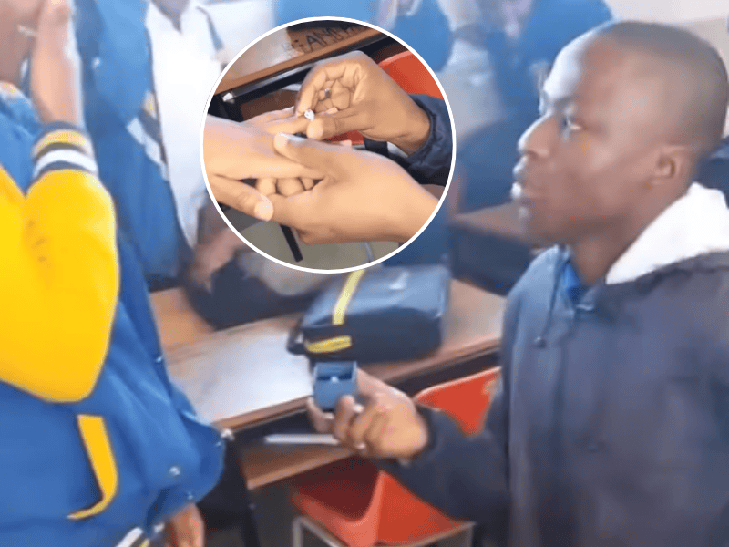 A schoolboy proposes to a schoolgirl in their classroom