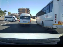 A security dash cam video shows bus overtake a taxi on oncoming lane