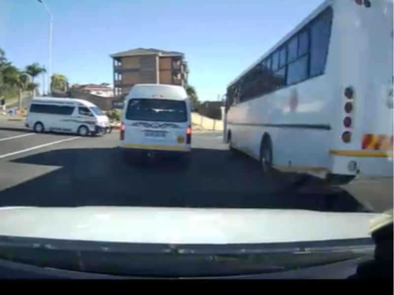 A security dash cam video shows bus overtake a taxi on oncoming lane