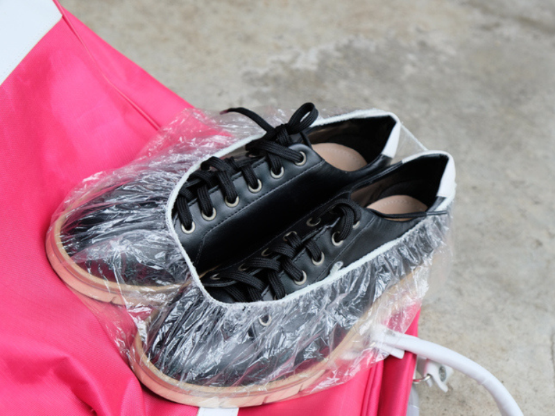 A shower cap is used to store shoes for travel