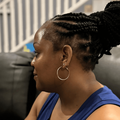 A side profile of Carol Ofori sitting on a couch