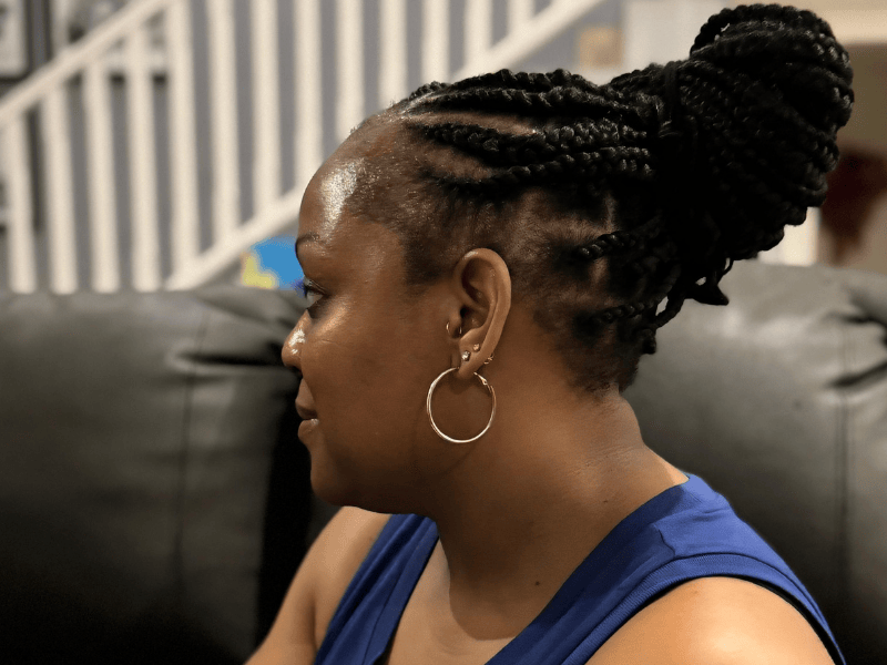 A side profile of Carol Ofori sitting on a couch