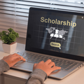 A student looking for scholarship on a laptop