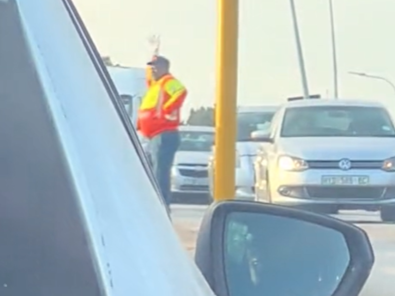 A traffic controller dances while directing traffic