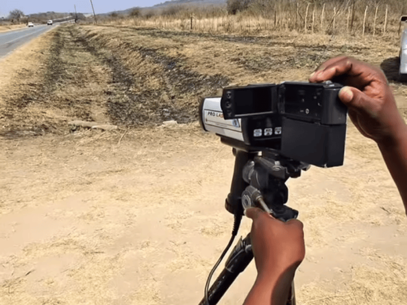 A traffic officer focuses the speed camera on a freeway