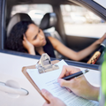 A traffic officer issuing a female driver a fine