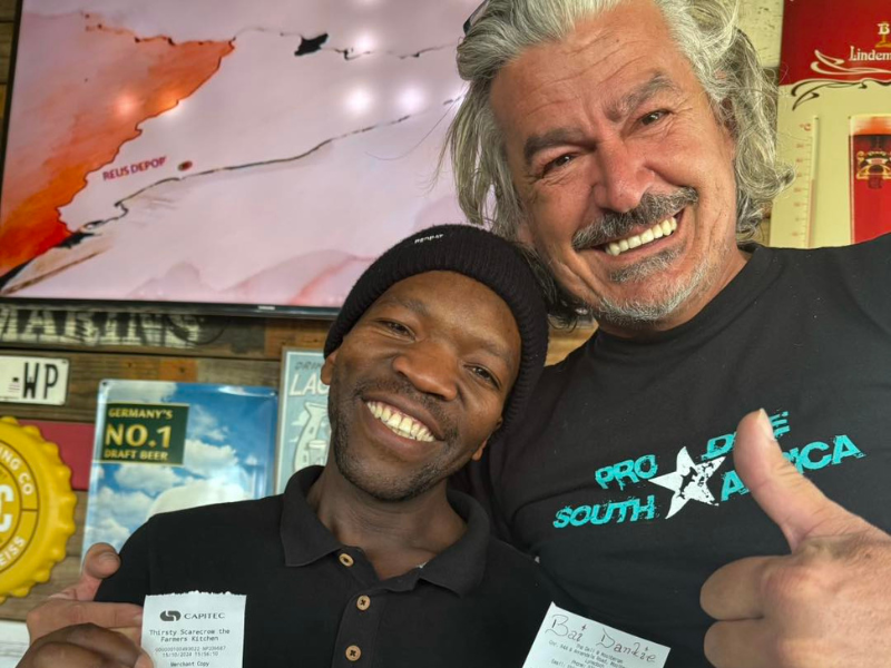 Waiter poses with customer's receipt with big tip