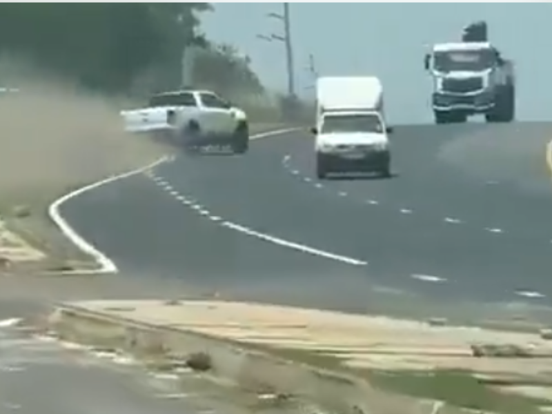 A white bakkie swerves on the freeway trying to avoid other vehicles