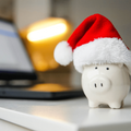 A white piggy bank with a red santa hat