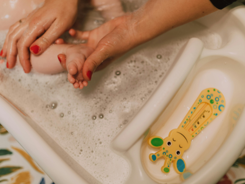 A woman bathing a baby