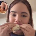 A woman biting into a sandwiched samoosa