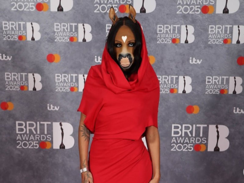 A woman dressed as a horse wearing a red dress at the Brit Awards 2025