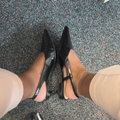 A woman has two different pairs of shoes