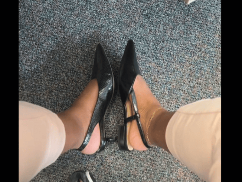A woman has two different pairs of shoes