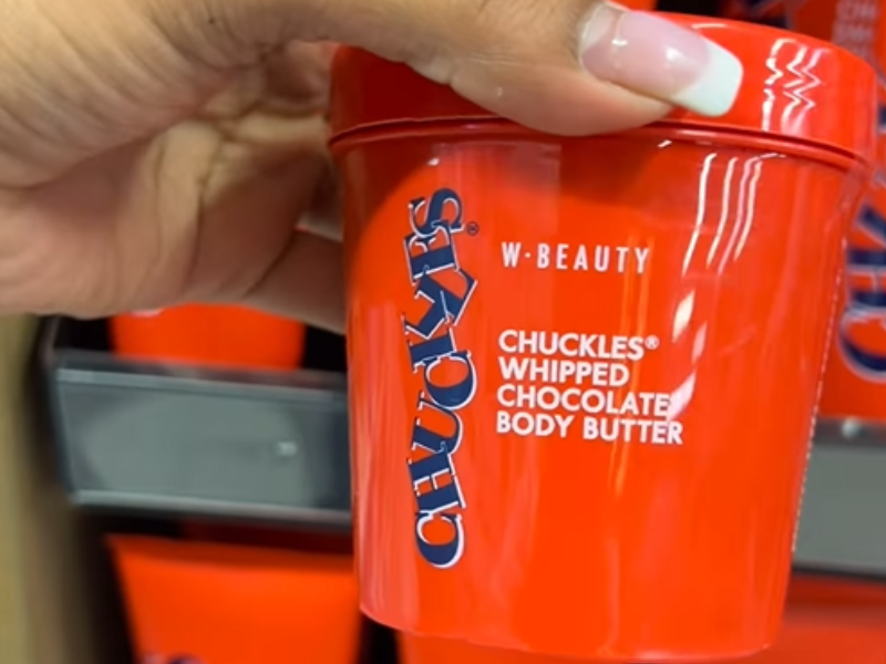 A woman holding a Chuckles chocolate body butter