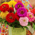 A woman holding a bunch of flowers inside a can