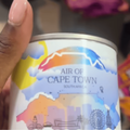 A woman holds a tin of canned air from Cape Town
