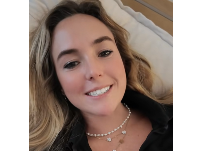 A woman lying on her bed smiling