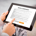 A woman reading a rental agreement on a tablet
