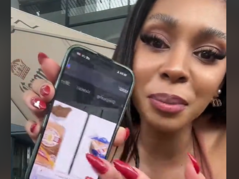 A woman scrolls through a photo of a popular South African bread