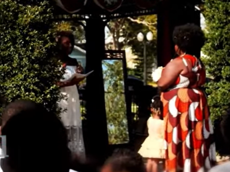 A woman standing in front of a mirror marrying herself
