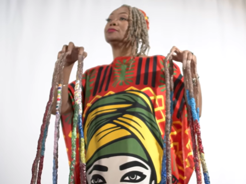 A woman stands showing off the longest nails in the world