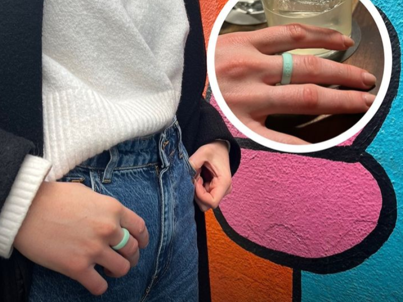 A woman wearing a blue green ring