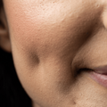 A woman with a dimple on her cheek
