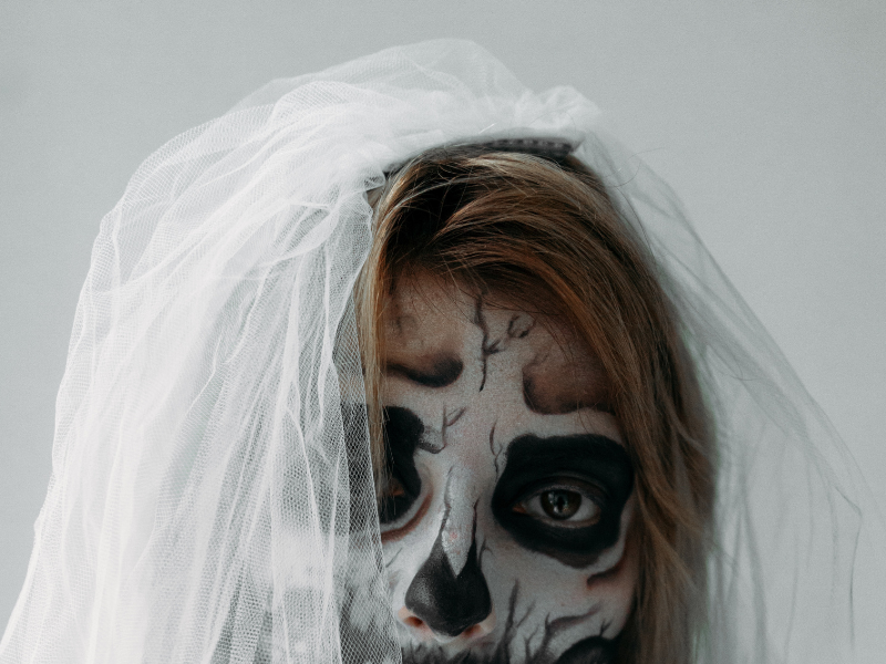 A woman with a scary face dressed as a bride
