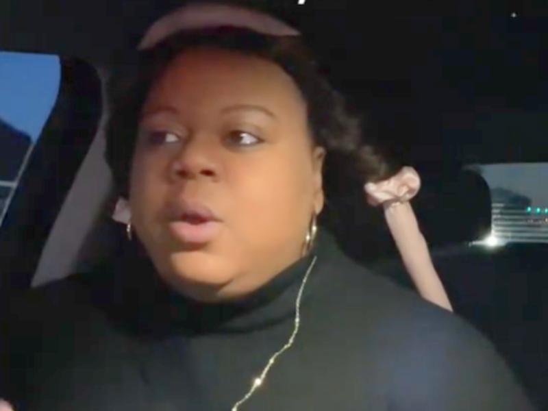 A woman with rollers in her hair in the driver's seat