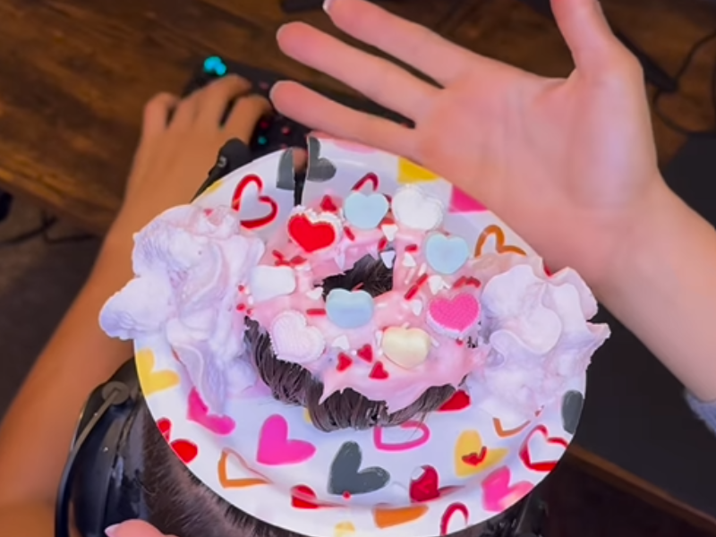 A woman's hands making a man's hair into donut hair