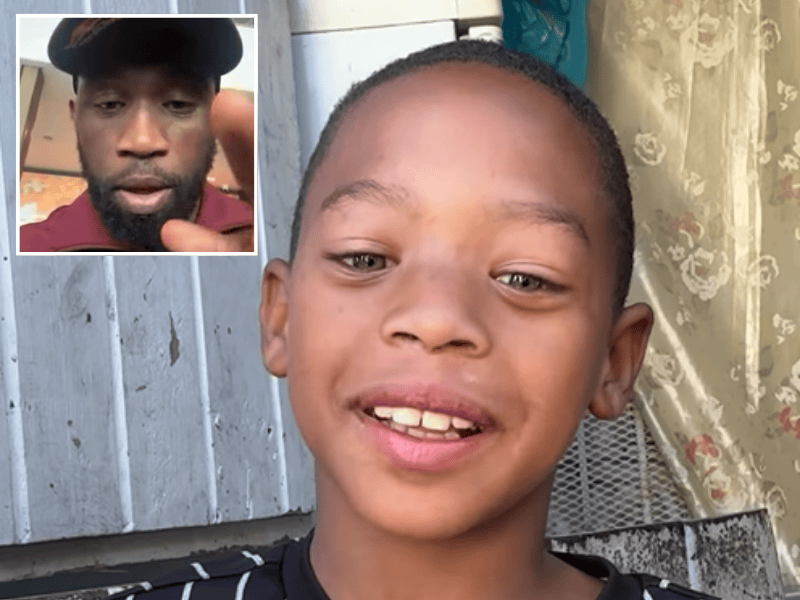 A young boy smiles as Siya Kolisi stands up for him against bullying